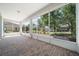 Spacious screened lanai featuring a brick paver floor and views of the lush backyard at 8640 Sw 83Rd Loop, Ocala, FL 34481