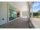 Covered lanai with sliding glass doors that open to reveal the kitchen and outdoor views at 8640 Sw 83Rd Loop, Ocala, FL 34481