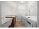 A laundry room with a sink, counter space, and storage shelves above the washer/dryer at 8640 Sw 83Rd Loop, Ocala, FL 34481