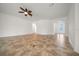 Open living space with tile flooring, a ceiling fan, and access to other areas of the home at 8640 Sw 83Rd Loop, Ocala, FL 34481