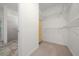 Walk-in closet with shelves, carpet, and access to Primary bath at 8640 Sw 83Rd Loop, Ocala, FL 34481