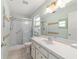 Bathroom featuring a glass-enclosed shower and ample vanity space at 8704 Sw 94Th Ln # G, Ocala, FL 34481