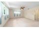 Light-filled bedroom features a ceiling fan and large windows at 8704 Sw 94Th Ln # G, Ocala, FL 34481