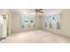 Bright bedroom with large windows covered in sheer blue curtains at 8704 Sw 94Th Ln # G, Ocala, FL 34481