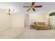 Open living space with carpet, ceiling fan, and chandelier offers a versatile and comfortable environment at 8704 Sw 94Th Ln # G, Ocala, FL 34481