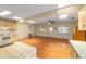 Light-filled living area with skylights, wood floors, and kitchen access at 8704 Sw 94Th Ln # G, Ocala, FL 34481