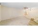 Spacious living room with neutral carpet, ceiling fan, and large window for natural light at 8704 Sw 94Th Ln # G, Ocala, FL 34481