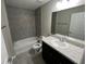 Bright bathroom showcasing tiled shower and flooring with a single sink vanity at 8795 Juniper Rd, Ocala, FL 34480