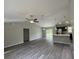 Open concept living area with modern lighting, ceiling fan, and seamless flow into the kitchen area at 8795 Juniper Rd, Ocala, FL 34480