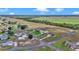 Aerial view of a home located in a rural community bordering a grass landing strip at 9641 Se 70Th Ter, Ocala, FL 34472