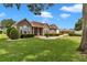 Inviting home with stone facade, well-maintained landscaping and healthy green lawn at 9641 Se 70Th Ter, Ocala, FL 34472