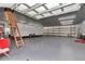 Spacious garage featuring a high ceiling, ample workspace, and a large trailer at 9641 Se 70Th Ter, Ocala, FL 34472