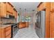 Charming kitchen features stainless steel appliances, granite countertops, and bright tile flooring at 9641 Se 70Th Ter, Ocala, FL 34472