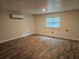 Cozy bedroom features a window, mini-split AC and wood-look flooring for comfortable living at 9805 Se 182Nd Avenue Rd, Ocklawaha, FL 32179