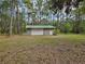 Detached garage with an overhead door, perfect for storage or as a workshop space at 9805 Se 182Nd Avenue Rd, Ocklawaha, FL 32179