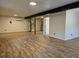 Open living area with modern floors and a spiral staircase at 9805 Se 182Nd Avenue Rd, Ocklawaha, FL 32179