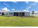 Spacious backyard with a screened lanai, lush lawn, and tasteful landscaping, creating a peaceful outdoor retreat at 10008 Sw 85Th Place Rd, Ocala, FL 34481