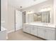 Spacious bathroom featuring double sinks with quartz countertops, shower, and ample counter space at 10008 Sw 85Th Place Rd, Ocala, FL 34481