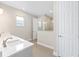 Bathroom featuring double sinks with quartz countertops, shower, and separate toilet area at 10008 Sw 85Th Place Rd, Ocala, FL 34481