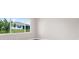 Bedroom with a large window overlooking the backyard and the home next door at 10008 Sw 85Th Place Rd, Ocala, FL 34481