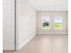 Bright, airy bedroom featuring two windows for natural light and wood-look flooring at 10008 Sw 85Th Place Rd, Ocala, FL 34481