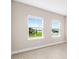 Bedroom showcasing two windows, bright interiors, and wood-look flooring at 10008 Sw 85Th Place Rd, Ocala, FL 34481
