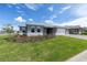 Well-maintained one-story home with a three-car garage and lush green lawn, set on a bright sunny day at 10008 Sw 85Th Place Rd, Ocala, FL 34481