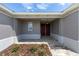 Elegant entryway showcasing a double door entry, paver walkway, and tasteful landscaping at 10008 Sw 85Th Place Rd, Ocala, FL 34481