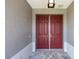 Close-up of the double front doors, offering a glimpse of the elegant exterior detailing and design at 10008 Sw 85Th Place Rd, Ocala, FL 34481