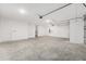 Spacious, bright garage with white concrete walls and multiple doors at 10008 Sw 85Th Place Rd, Ocala, FL 34481