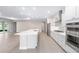 Open kitchen with stainless appliances, modern cabinets, large center island, and tile flooring at 10008 Sw 85Th Place Rd, Ocala, FL 34481