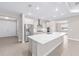 Bright, open kitchen with stainless steel appliances, white cabinetry, and a large center island at 10008 Sw 85Th Place Rd, Ocala, FL 34481