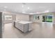 Spacious kitchen features a large island with a sink, ample cabinet space, and access to a bright living area at 10008 Sw 85Th Place Rd, Ocala, FL 34481