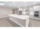Well-lit kitchen featuring a large island, stainless steel appliances, and ample storage space at 10008 Sw 85Th Place Rd, Ocala, FL 34481