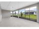 Covered lanai with screened windows and gray concrete flooring at 10008 Sw 85Th Place Rd, Ocala, FL 34481