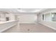 Open concept living room and kitchen area with white cabinets, island, and tile flooring at 10008 Sw 85Th Place Rd, Ocala, FL 34481