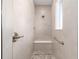 Tiled shower with built-in bench, handheld sprayer, and convenient grab bar at 10008 Sw 85Th Place Rd, Ocala, FL 34481