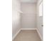 Bright walk-in closet with installed shelving and wood-look flooring at 10008 Sw 85Th Place Rd, Ocala, FL 34481