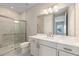Well-lit bathroom showcasing a glass-enclosed shower and a white vanity with ample counter space at 10026 Sw 85Th Place Rd, Ocala, FL 34481