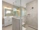 Contemporary bathroom featuring glass-enclosed shower, modern fixtures, and neutral tones at 10026 Sw 85Th Place Rd, Ocala, FL 34481