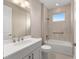 Well-lit bathroom featuring a bathtub with a shower, a window, and a vanity with bronze hardware at 10026 Sw 85Th Place Rd, Ocala, FL 34481