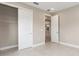 Bedroom with a closet, open door and neutral tones creating a calming space at 10026 Sw 85Th Place Rd, Ocala, FL 34481