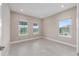 Bright bedroom with three windows offering natural light and a view of the surrounding landscape at 10026 Sw 85Th Place Rd, Ocala, FL 34481