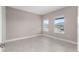 Neutral bedroom with tile flooring and two windows providing natural light and neighborhood views at 10026 Sw 85Th Place Rd, Ocala, FL 34481