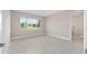 Bright, neutral bedroom with large window offering a view to the backyard and an en-suite bathroom at 10026 Sw 85Th Place Rd, Ocala, FL 34481