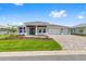 Well-maintained single-story home boasts a three-car garage, patterned brick driveway, and an inviting front lawn at 10026 Sw 85Th Place Rd, Ocala, FL 34481