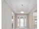 Bright foyer featuring tile flooring, neutral walls, and a decorative glass front door for a welcoming entrance at 10026 Sw 85Th Place Rd, Ocala, FL 34481