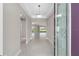 Open foyer with a decorative front door, tile flooring, and a view into the bright and airy living space at 10026 Sw 85Th Place Rd, Ocala, FL 34481