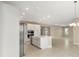 Modern kitchen boasts stainless steel appliances, a center island, and ample cabinet space at 10026 Sw 85Th Place Rd, Ocala, FL 34481