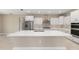 Modern kitchen with stainless steel appliances, white cabinets, and quartz countertops at 10026 Sw 85Th Place Rd, Ocala, FL 34481